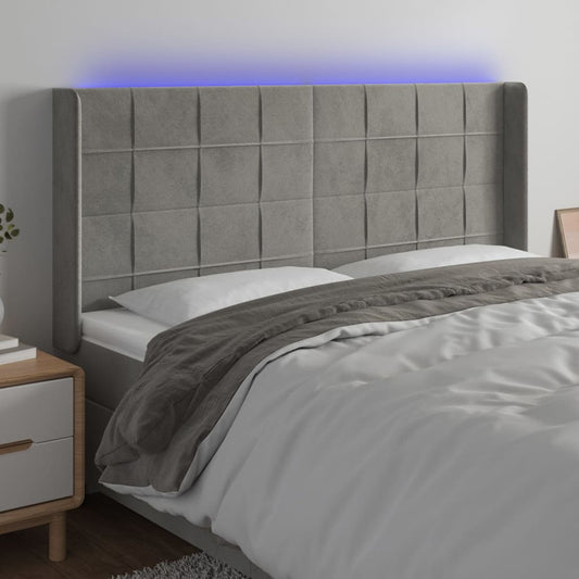 Sänggavel LED ljusgrå 163x16x118/128 cm sammet